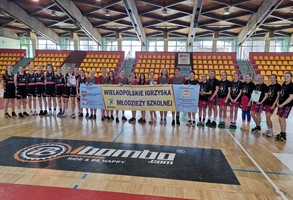 Grupa dziewczyn z drużyn koszykarskich z transparentem